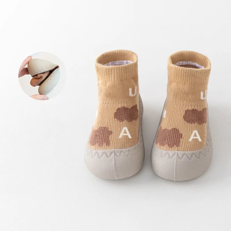 Zapato infantil con calcetín y suela de goma suave.