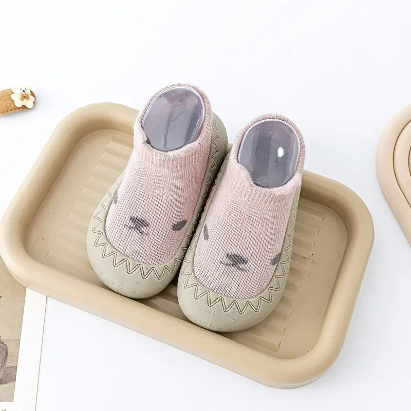 Zapato infantil con calcetín y suela de goma suave.